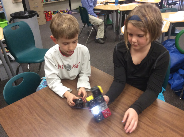 Two of Ms. Grindle's students show off the Cubelets robot that they built together
